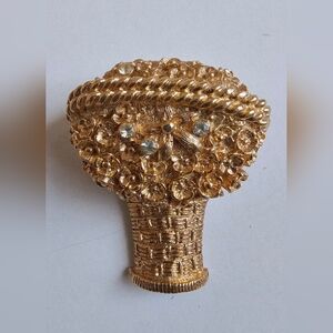 vintage Avon solid perfume brooch in the shape of a gold flower basket.